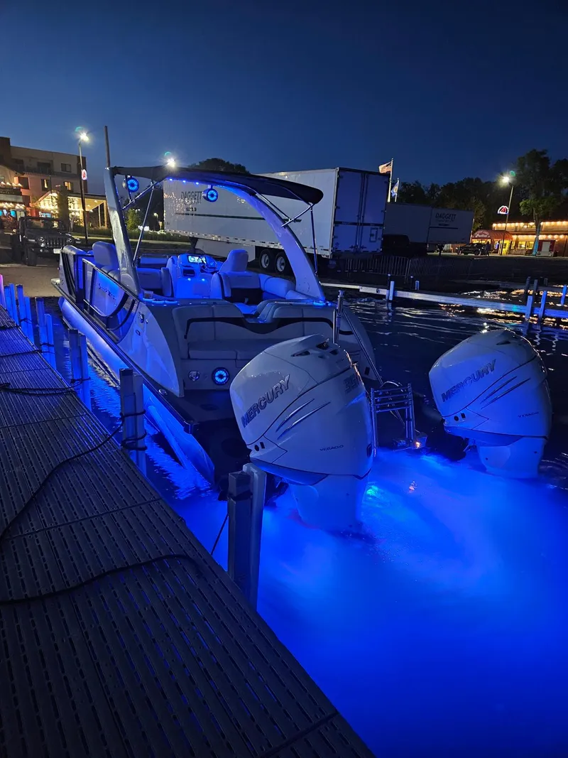 Slide: The Image of 2019 South Bay 25SPORT CR9 3.0 boat with blue underwater lights at dock. - 1