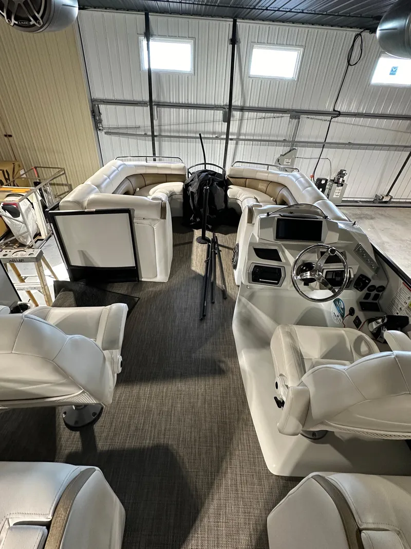 Slide: The Image of 2019 South Bay 25SPORT CR9 3.0 boat interior with white seating and modern dashboard. - 10