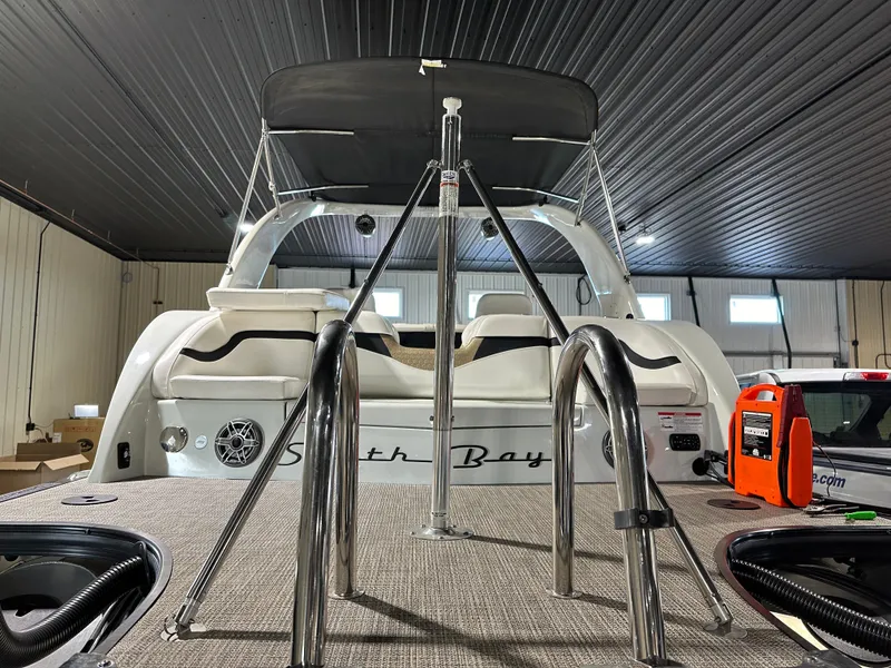 Slide: The Image of 2019 South Bay 25SPORT CR9 3.0 pontoon boat in indoor storage. - 12