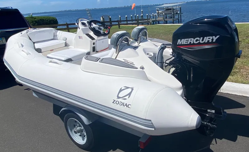 Slide: The Image of 2024 Zodiac Yachtline 360 inflatable boat with Mercury outboard motor on trailer. - 13