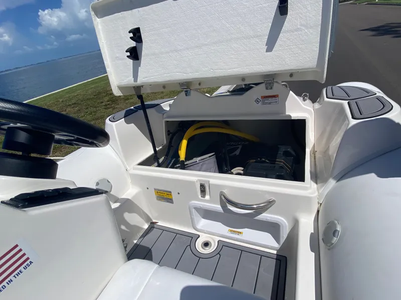 Slide: The Image of 2024 Zodiac Yachtline 360 storage compartment with open lid, showing interior and equipment. - 4