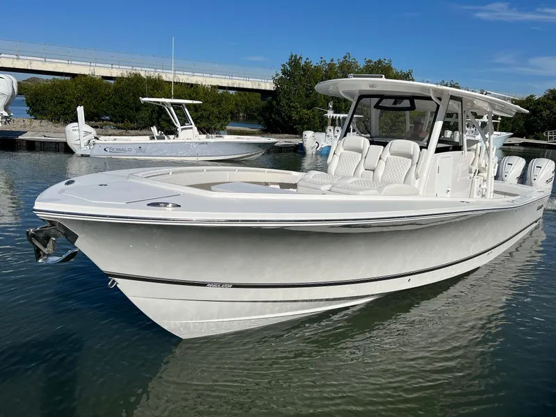 Slide: The Image of 2024 Regulator 41 boat docked in calm waters under a clear blue sky. - 10
