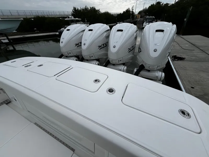 Slide: The Image of 2024 Regulator 41 boat with four powerful outboard engines docked. - 17