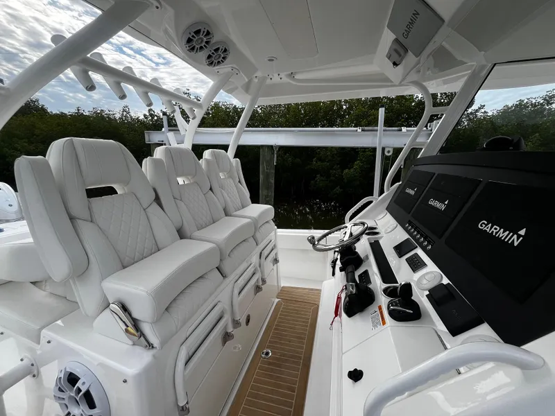 Slide: The Image of 2024 Regulator 41 boat interior with white seating and Garmin navigation system. - 26