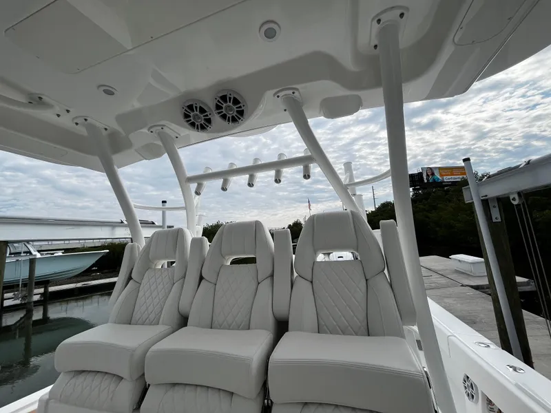 Slide: The Image of 2024 Regulator 41 boat interior with luxurious white seating and overhead speakers. - 29