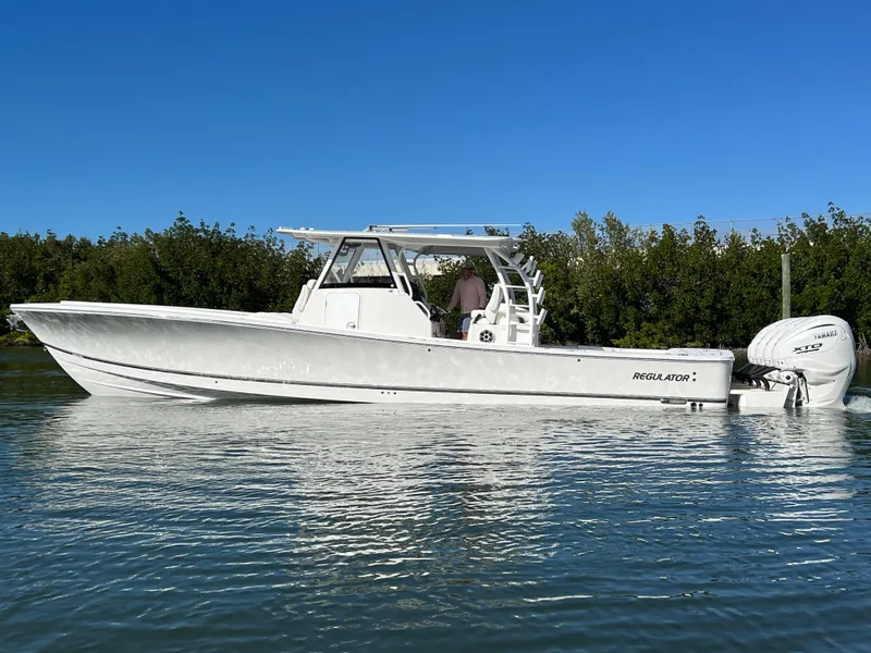 Slide: The Image of 2024 Regulator 41 boat on calm water, clear sky background. - 3