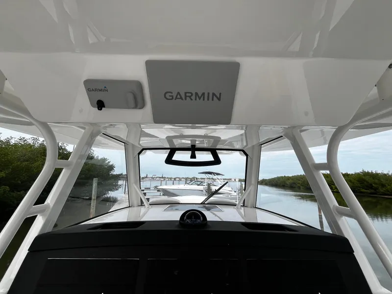 Slide: The Image of 2024 Regulator 41 boat with Garmin navigation system, docked in a serene marina. - 31