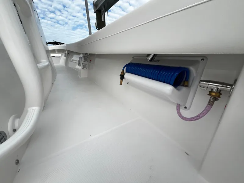 Slide: The Image of 2024 Regulator 41 boat deck with hose storage and clean white finish. - 32