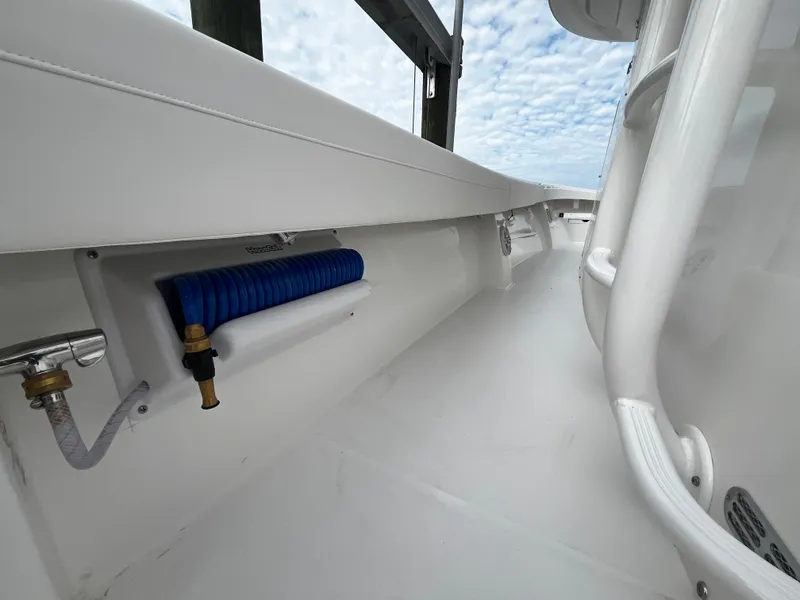 Slide: The Image of 2024 Regulator 41 boat deck with blue hose and white interior. - 34