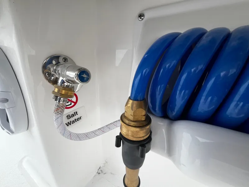 Slide: The Image of 2024 Regulator 41 saltwater hose connection with blue coiled hose. - 35