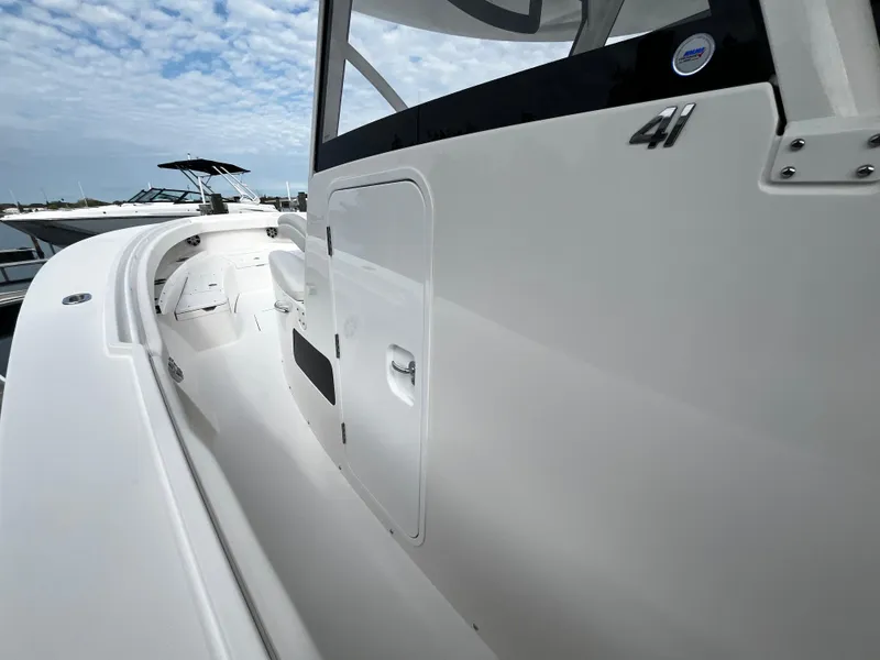 Slide: The Image of 2024 Regulator 41 boat side view with sleek white design. - 36