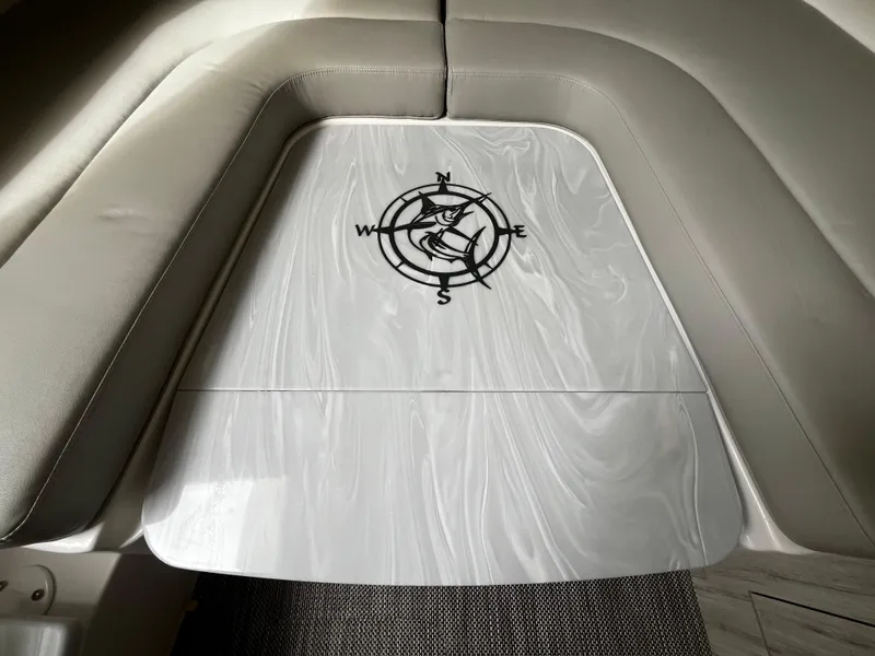 Slide: The Image of 2024 Regulator 41 boat interior with compass design on table. - 39