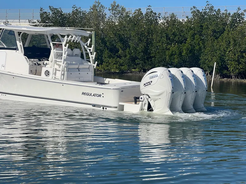 Slide: The Image of 2024 Regulator 41 boat with four Yamaha engines on calm water. - 4