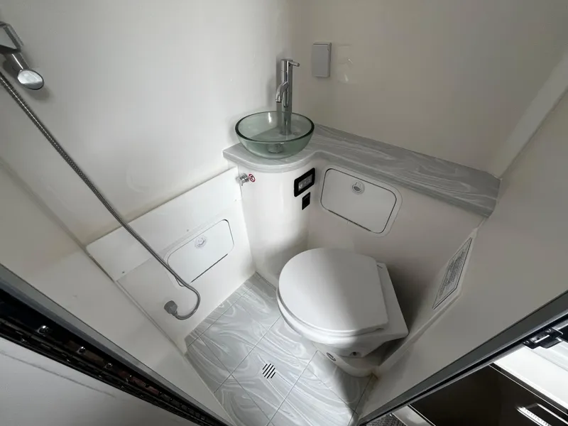 Slide: The Image of 2024 Regulator 41 boat bathroom with modern fixtures and glass sink. - 42