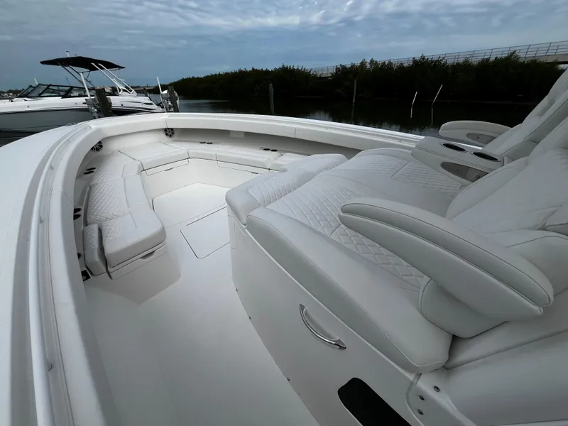 Slide: The Image of 2024 Regulator 41 boat with luxurious white seating and spacious deck. - 45