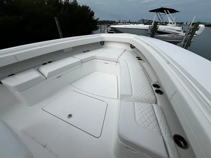 Slide: The Image of 2024 Regulator 41 boat with spacious white seating area and sleek design. - 46