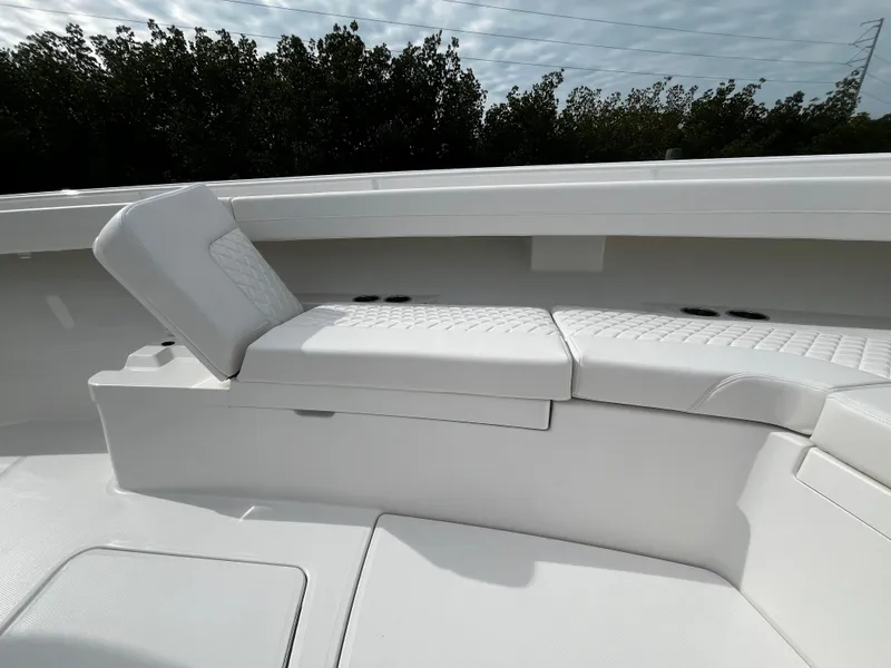 Slide: The Image of 2024 Regulator 41 boat with white cushioned seating area. - 47