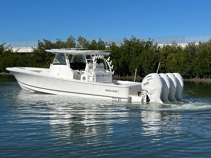 Slide: The Image of 2024 Regulator 41 boat with triple outboard engines on calm water. - 5