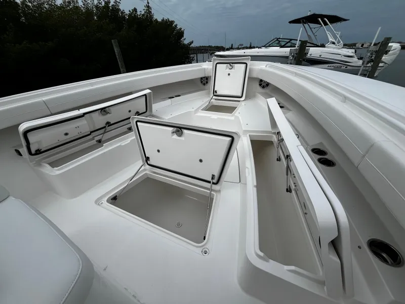 Slide: The Image of 2024 Regulator 41 boat with open storage compartments on deck. - 50