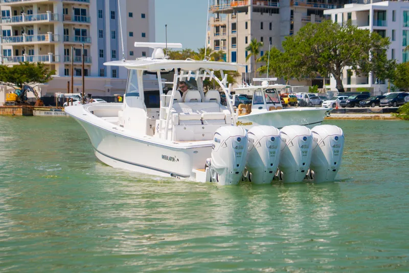 Slide: The Image of 2024 Regulator 41 boat with four Yamaha engines in a marina setting. - 55