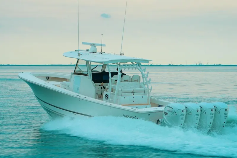 Slide: The Image of 2024 Regulator 41 boat cruising on calm water with four powerful engines. - 59