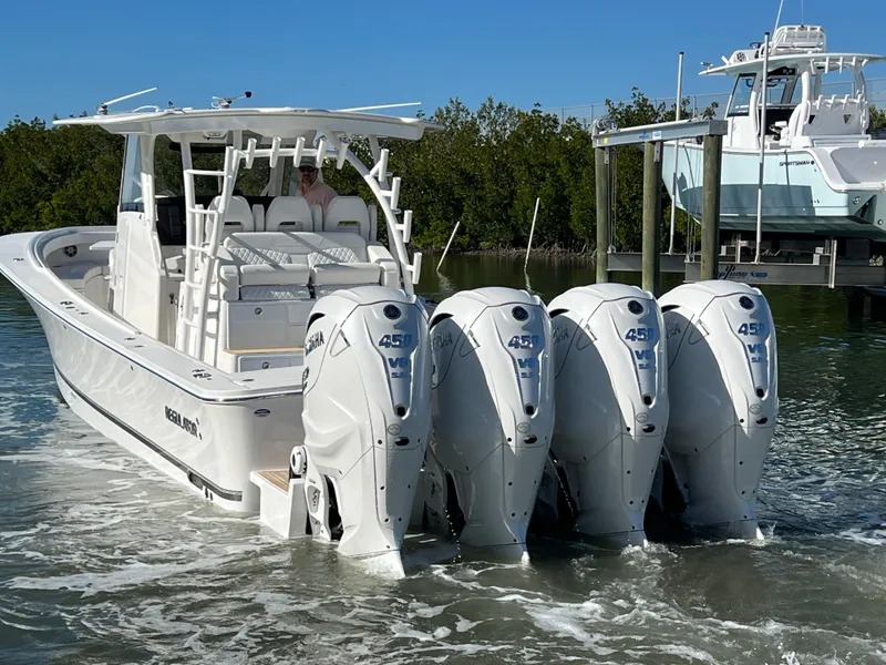 Slide: The Image of 2024 Regulator 41 boat with four powerful outboard engines in a marina setting. - 6