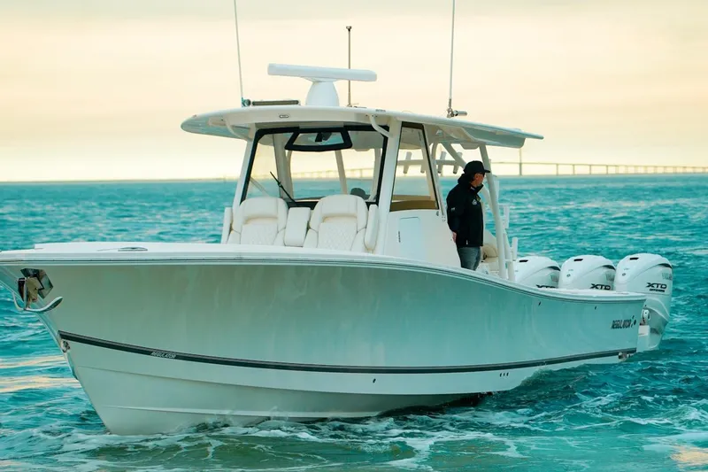 Slide: The Image of 2024 Regulator 41 boat cruising on open water with multiple engines. - 60