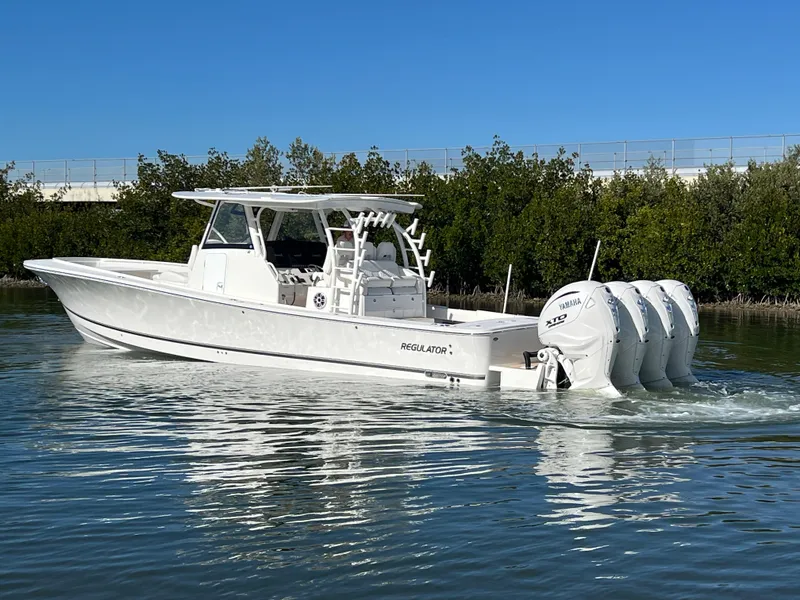 Slide: The Image of 2024 Regulator 41 boat with four engines cruising on calm water. - 8