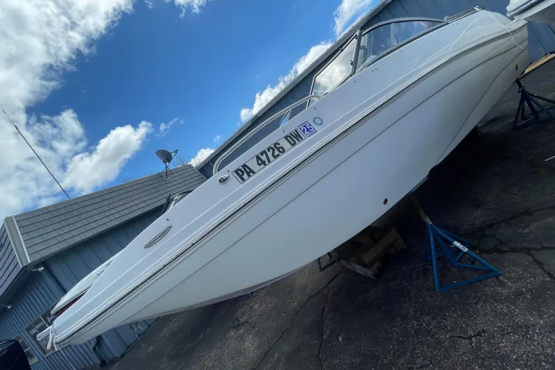 Slide: The Image of 2019 Hurricane 217 Sundeck boat on stands, side view, outdoors. - 5