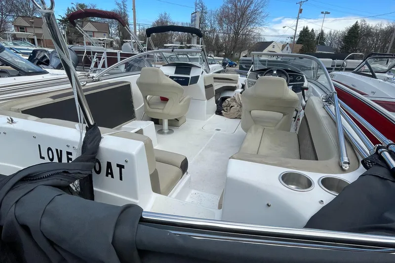 Slide: The Image of 2019 Hurricane 217 Sundeck boat with beige seating and Love Boat text on the back. - 8
