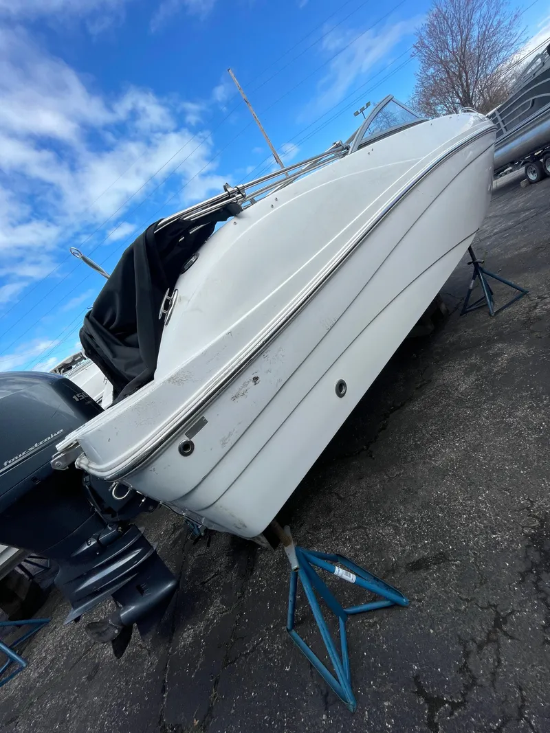 Slide: The Image of 2019 Hurricane 217 Sundeck boat on stands, white hull, outdoor display. - 9