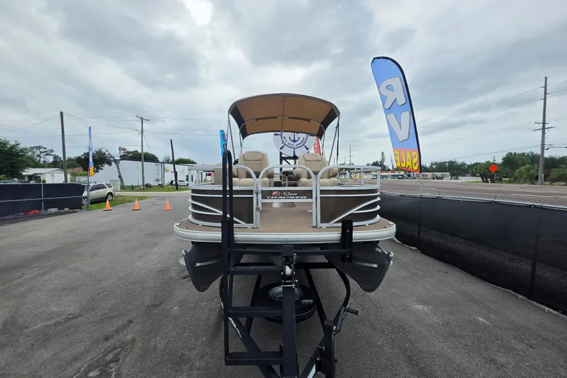 Slide: The Image of 2023 Sun Tracker Bass Buggy 18 DLX pontoon boat on display at a dealership. - 10