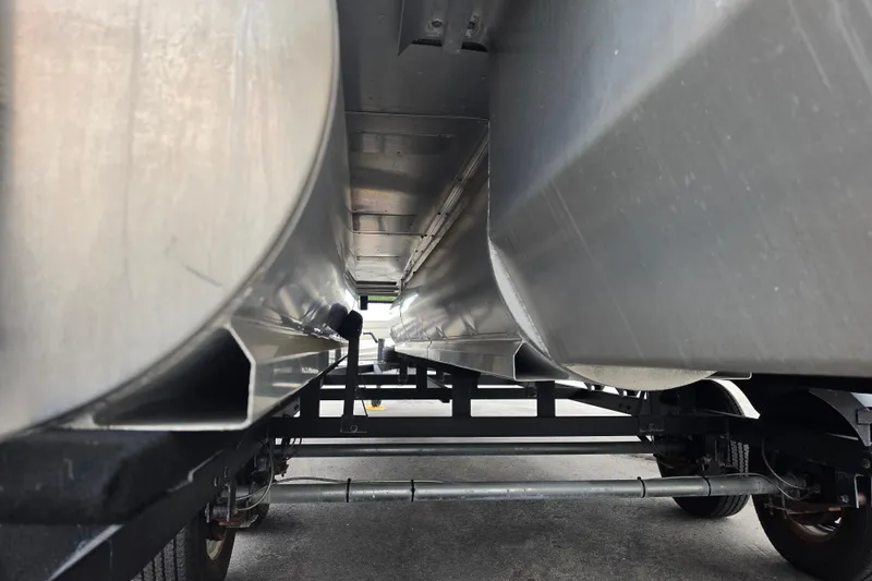 Slide: The Image of Underneath view of 2023 Sun Tracker Bass Buggy 18 DLX pontoon boat on trailer. - 12