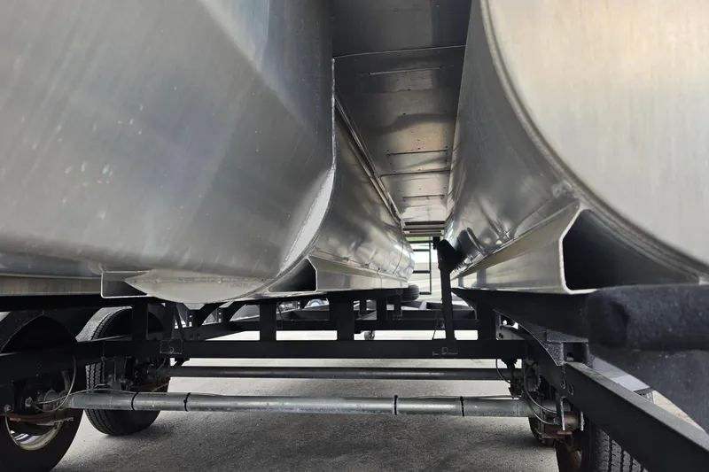 Slide: The Image of Underneath view of 2023 Sun Tracker Bass Buggy 18 DLX pontoon boat on trailer. - 13
