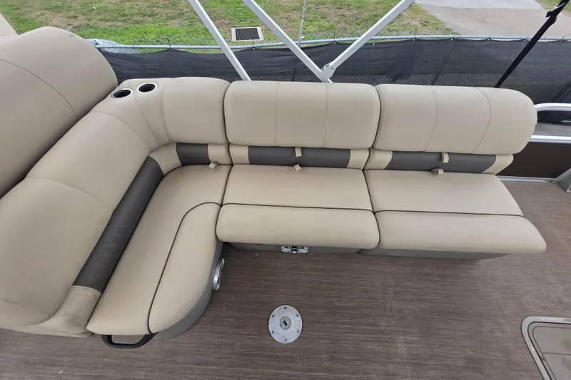 Slide: The Image of 2023 Sun Tracker Bass Buggy 18 DLX pontoon boat with beige seating and cup holders. - 19