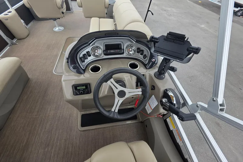 Slide: The Image of 2023 Sun Tracker Bass Buggy 18 DLX boat dashboard with steering wheel and controls. - 21