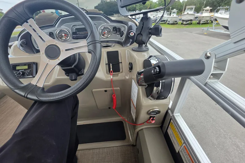 Slide: The Image of 2023 Sun Tracker Bass Buggy 18 DLX dashboard with steering wheel and controls. - 22