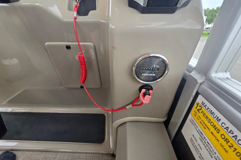 Slide: The Image of 2023 Sun Tracker Bass Buggy 18 DLX dashboard with hour meter and safety lanyard. - 29
