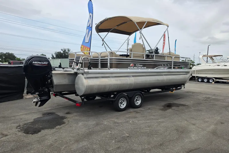 Slide: The Image of 2023 Sun Tracker Sportfish 24 XP3 pontoon boat with Mercury outboard motor on trailer. - 3