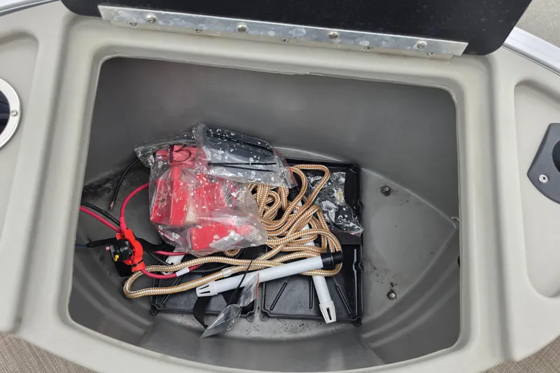 Slide: The Image of Storage compartment of 2023 Sun Tracker Bass Buggy 18 DLX with ropes and accessories. - 38