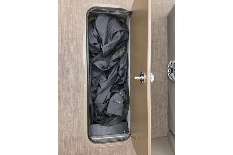Slide: The Image of Storage compartment of 2023 Sun Tracker Bass Buggy 18 DLX with black cover inside. - 43