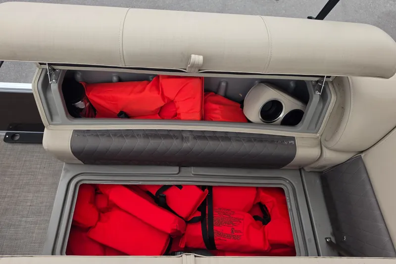 Slide: The Image of Storage compartments with life jackets on a 2023 Sun Tracker Bass Buggy 18 DLX boat. - 45