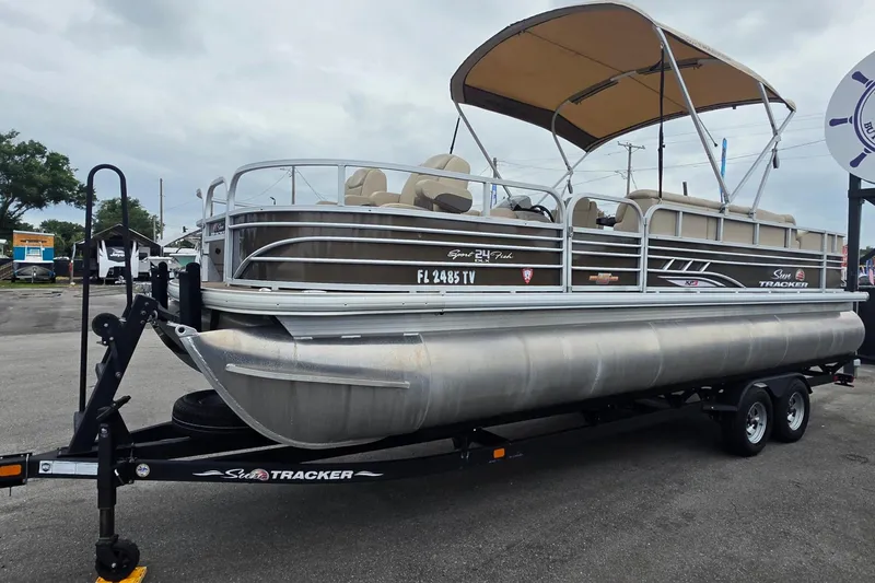 Slide: The Image of 2023 Sun Tracker Bass Buggy 18 DLX pontoon boat on trailer at dealership. - 8