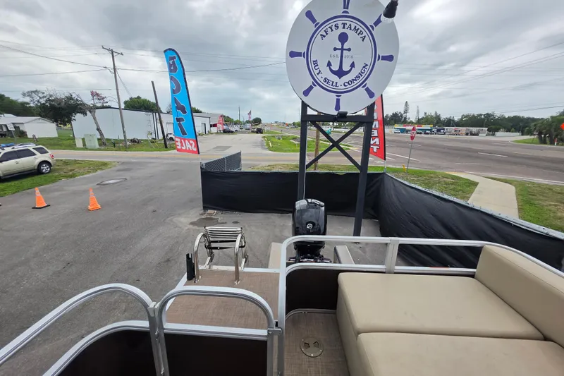 Slide: The Image of 2023 Sun Tracker Bass Buggy 18 DLX pontoon boat at a sales lot with signage. - 50