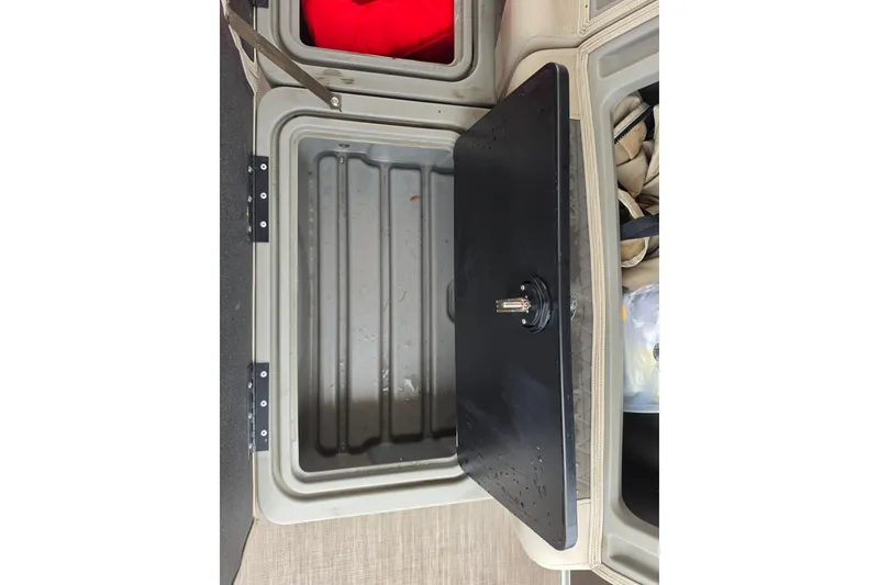 Slide: The Image of Storage compartment of 2023 Sun Tracker Bass Buggy 18 DLX boat, featuring a black lid. - 54