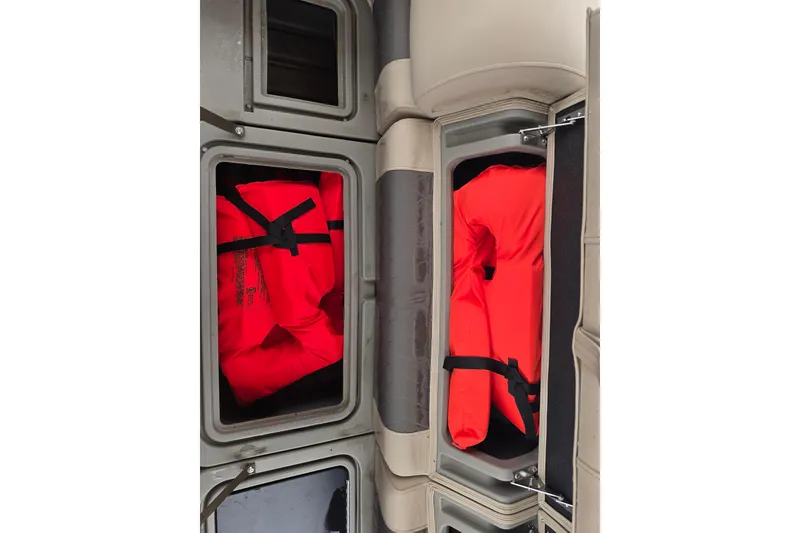 Slide: The Image of Storage compartments with life jackets on a 2023 Sun Tracker Bass Buggy 18 DLX boat. - 56