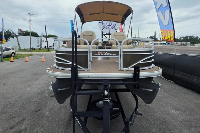 Slide: The Image of 2023 Sun Tracker Bass Buggy 18 DLX pontoon boat on display at a dealership. - 9