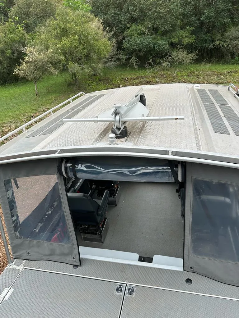 Slide: The Image of 2014 Wooldridge 31 boat with open cabin and rooftop view. - 13