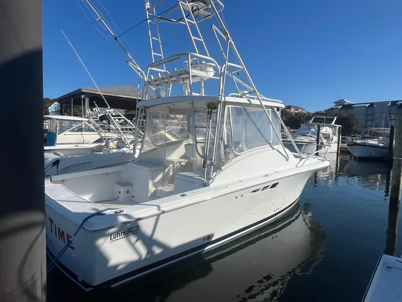 The Image of 1995 Luhrs Tournament 290 Open boat docked in marina on a sunny day. - 0