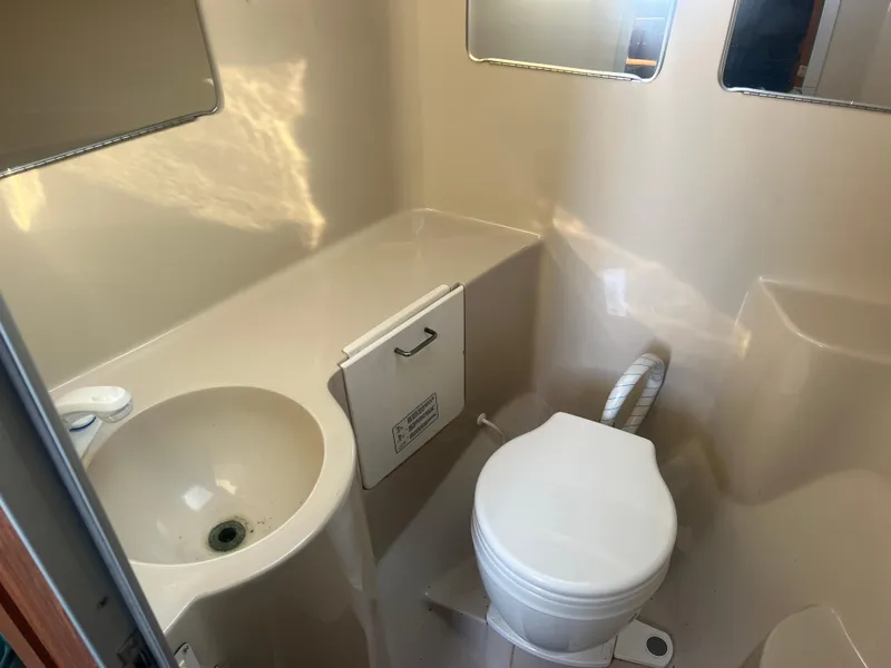 Slide: The Image of 1995 Luhrs Tournament 290 Open boat bathroom with sink and toilet. - 21